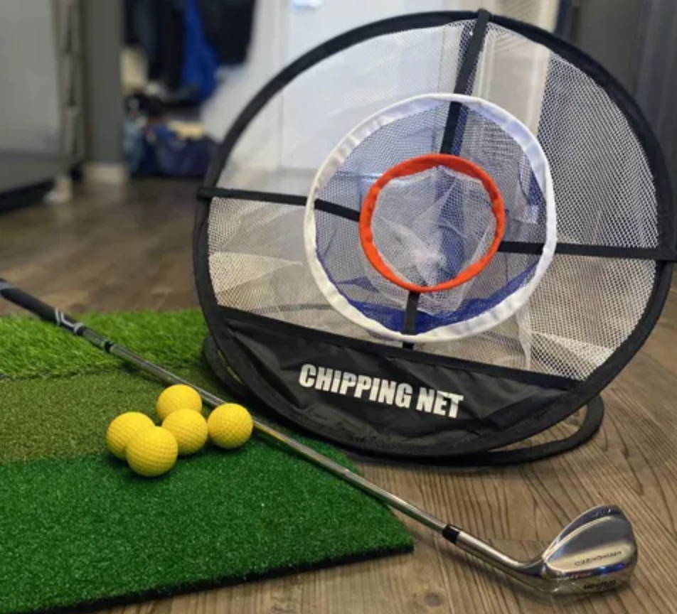 Golf chipping net with black carrying strap on a white background